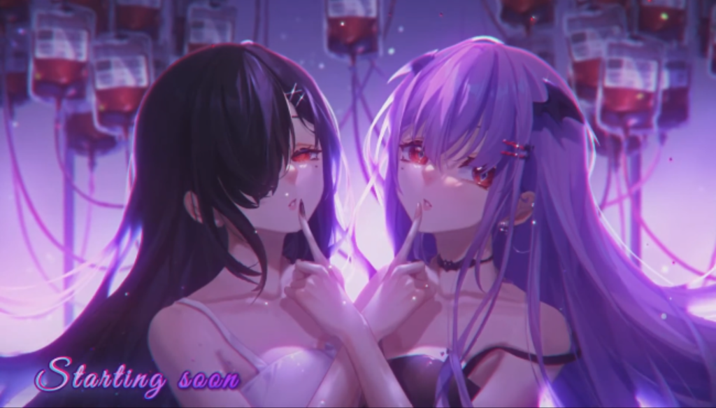 Mythia Batford is an Indonesian virtual youtuber that claimed herself to be a vampire. This picture depicts her with another girl, touching down their lips with each other's index finger, with a background full of blood packets usually found in blood donation stands.