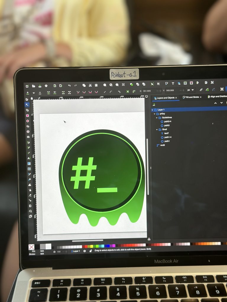 A picture of a laptop opening a draft drawing of alterine/alt1e in Inkscape.